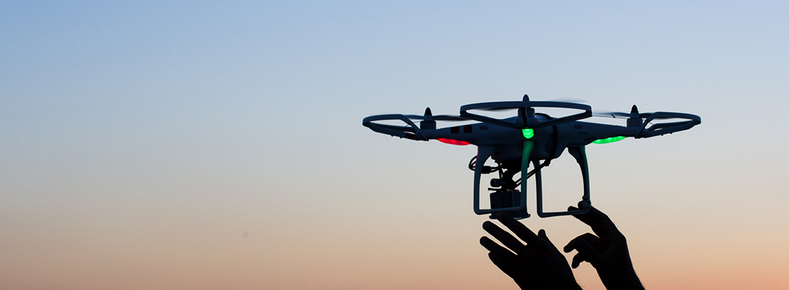 Viareggio, Italy - October 30, 2014: Drone takes off from the operator's hand with camera at sunset Quadcopter industry is told to be growing at triple digitsevery year, for a market expected to pass the 20 billion in the 2020. The dji is a chinese company leader of quadcopter industry, and the phantom is expected to be the top seller gift for christmas 2015